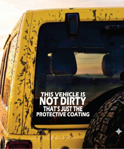 Back of a mud-splattered yellow truck with the bold ad text: "This vehicle is not dirty—that's just the protective coating".