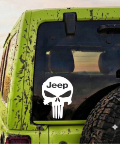 Mud-splattered green Jeep from the back, rear window with a white skull decal saying 'Jeep' and a rugged spare tire nearby