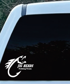 White JIG HEADS Fishing Team logo sticker with a stylized fish on the rear window of a light-blue vehicle.