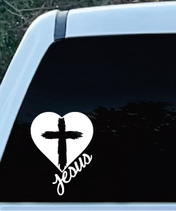 Heart-shaped white decal with a black cross and the word 'Jesus' on a car window