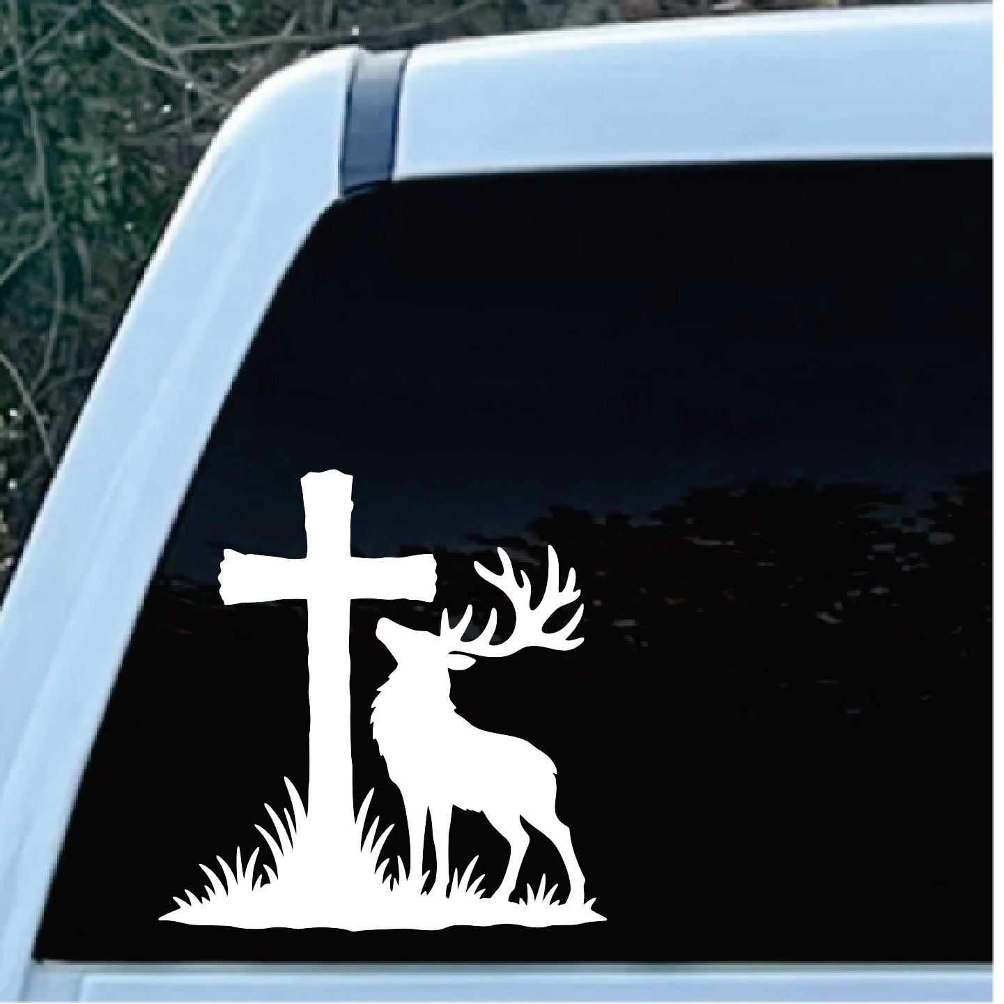 Stag Cross Window Decal Sticker | Custom Sticker Shop White silhouette of a deer with large antlers standing beside a cross on a grassy mound, as a vinyl sticker on a car window.