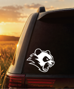 SUV with a white panda logo sticker on the rear window at sunset in a field